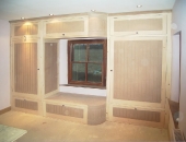 Tiered wardrobe with curved centre section stepped design to fit around window positions