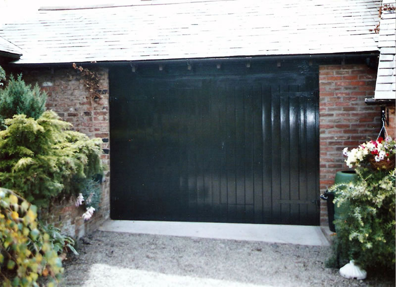 Classical style garage doors with adjacent pionting tidied up and concrete-ramp-renewed
