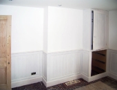 MDF T and G dado panelling and cupboard including drawer fronts split to match panelling