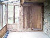 Plank and muntin style end wall with distressed ledge and braced door