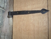 Traditional forged hinge in wrought iron with a knock in peg and pin