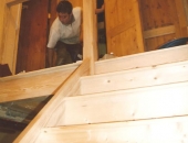 Landing cupboard doors being hung during stair case assembly