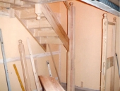 Yellow pine staircase newel posts and landing section being assembled